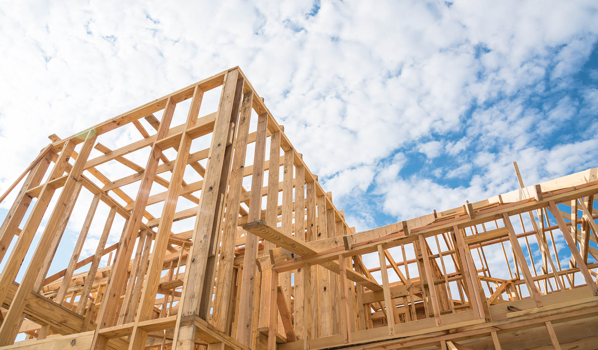 Close-up new built home under construction under blue sky