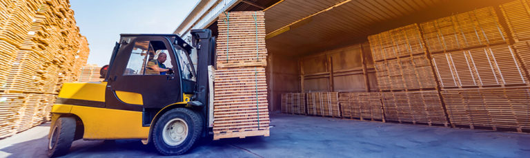Forklift loader load lumber into a dry kiln. Wood drying in containers.