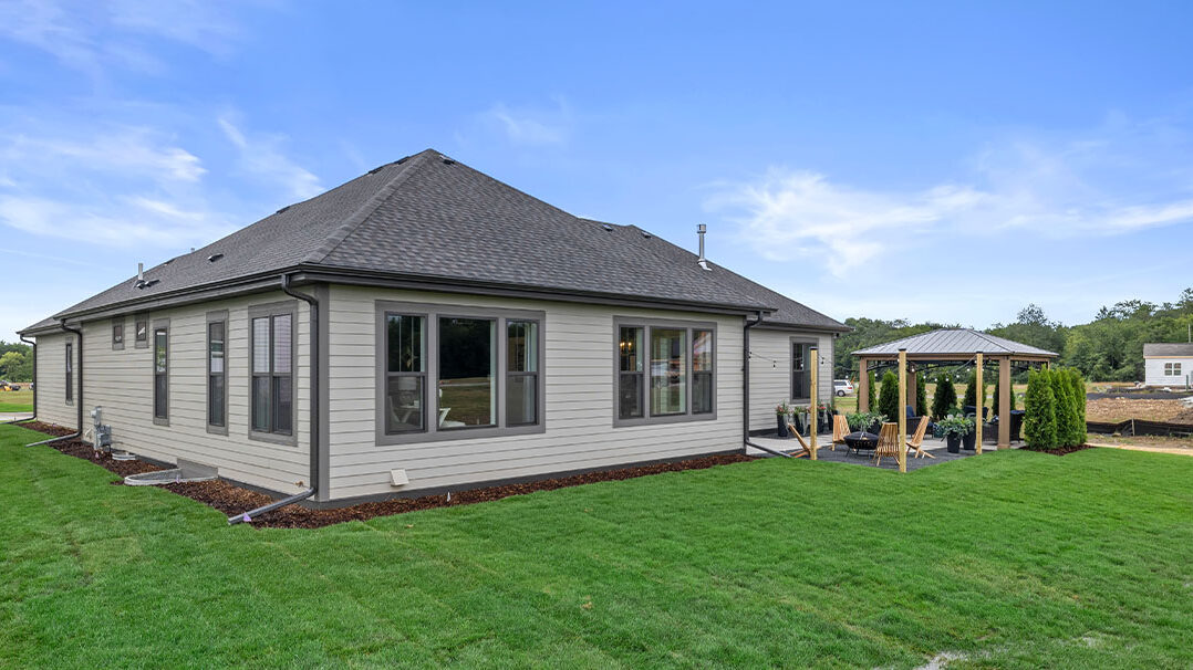 Parade of Homes model, The Lexi, exterior back yard showing off the sitting area with fireplace.