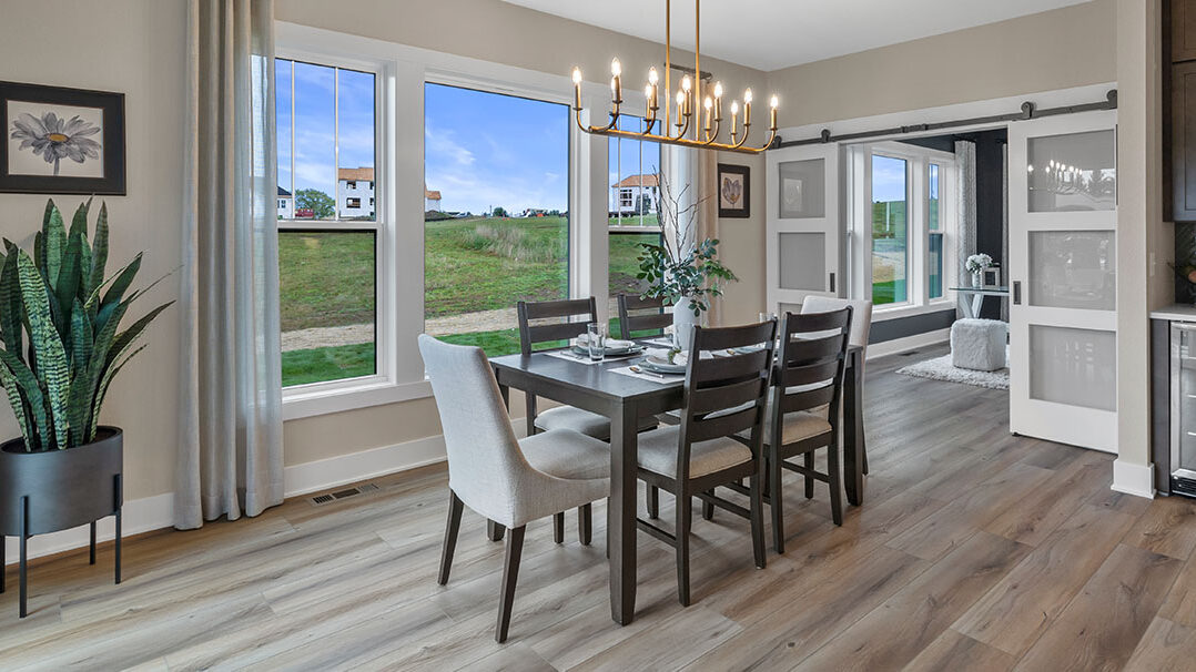 Parade of Homes model, The Lexi, dinning room with large picture windows looking to the backyard