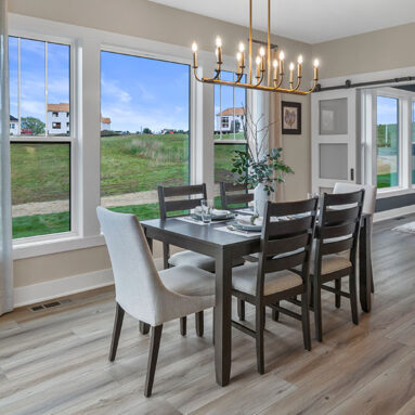 Parade of Homes model, The Lexi, dinning room with large picture windows looking to the backyard